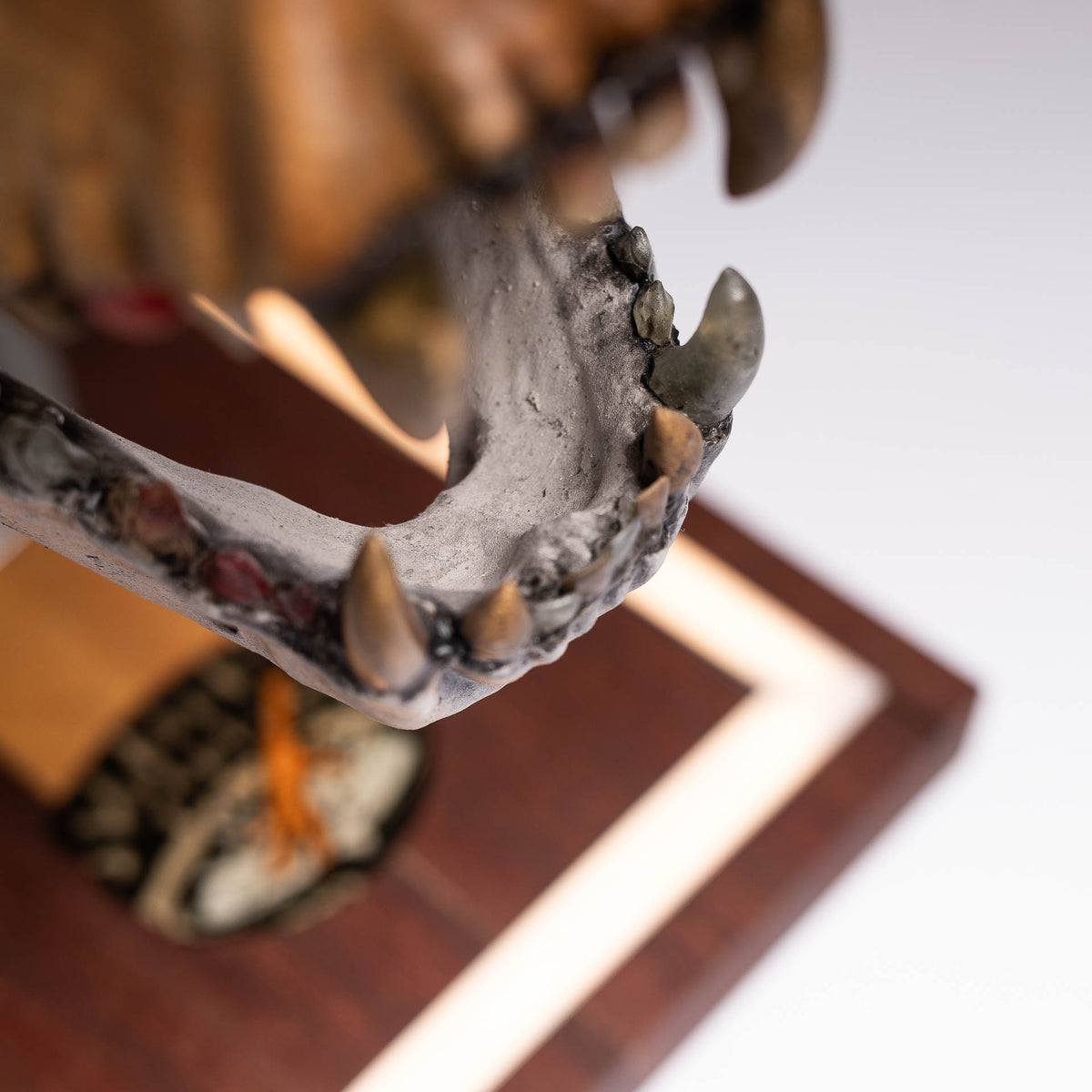 Detail of the 3D-printed concrete-look jaw above the wooden base with light inlay