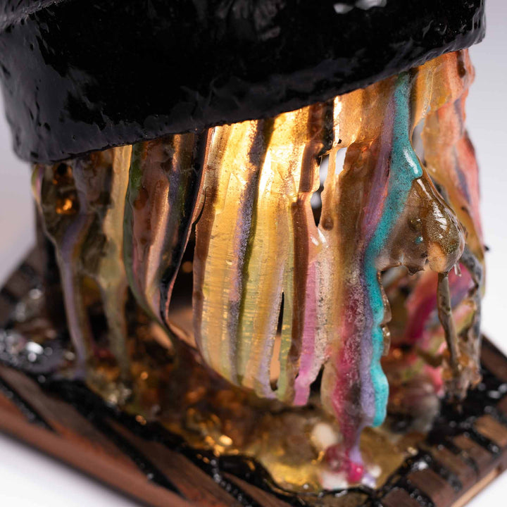 Detail of colorful resin strands lit from inside beneath the hat