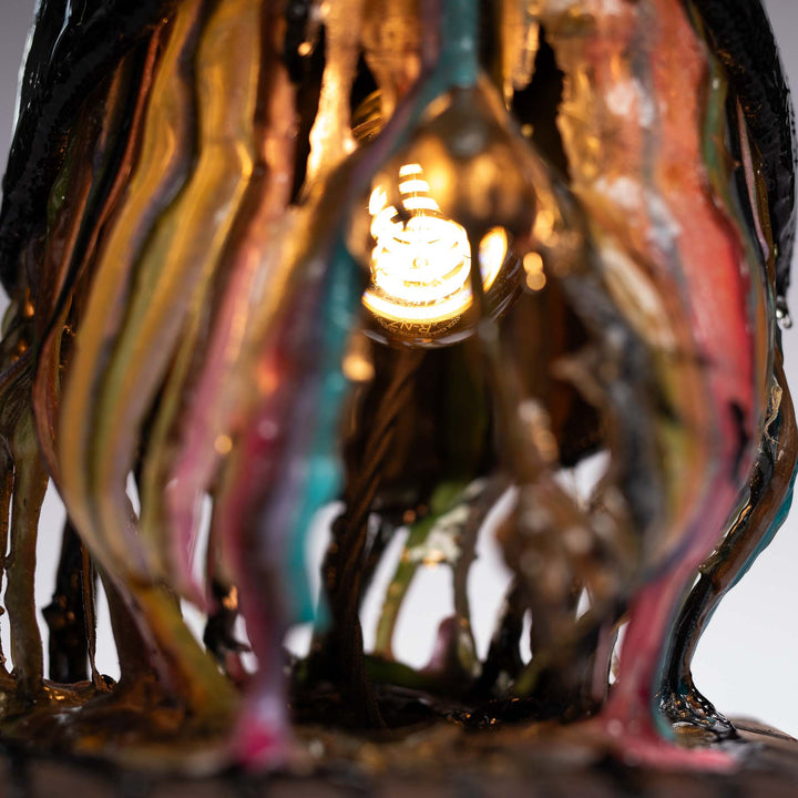 Close-up of the retro light bulb glowing inside the epoxy resin sculpture