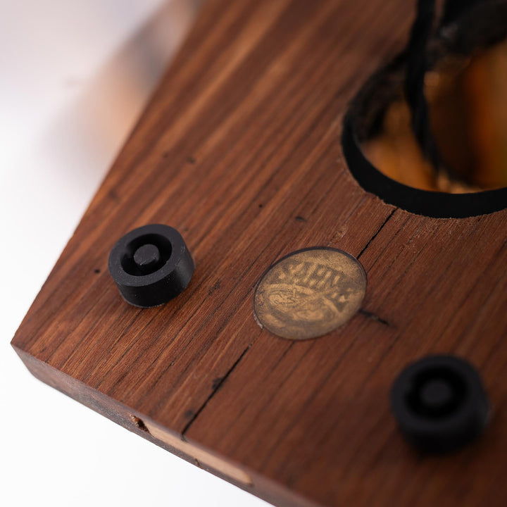 Underside of the wooden base with rubber feet and the sahne.studio emblem