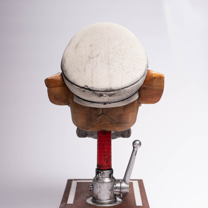 Dead Chase sculpture, back view showing the concrete cap and the red hose section