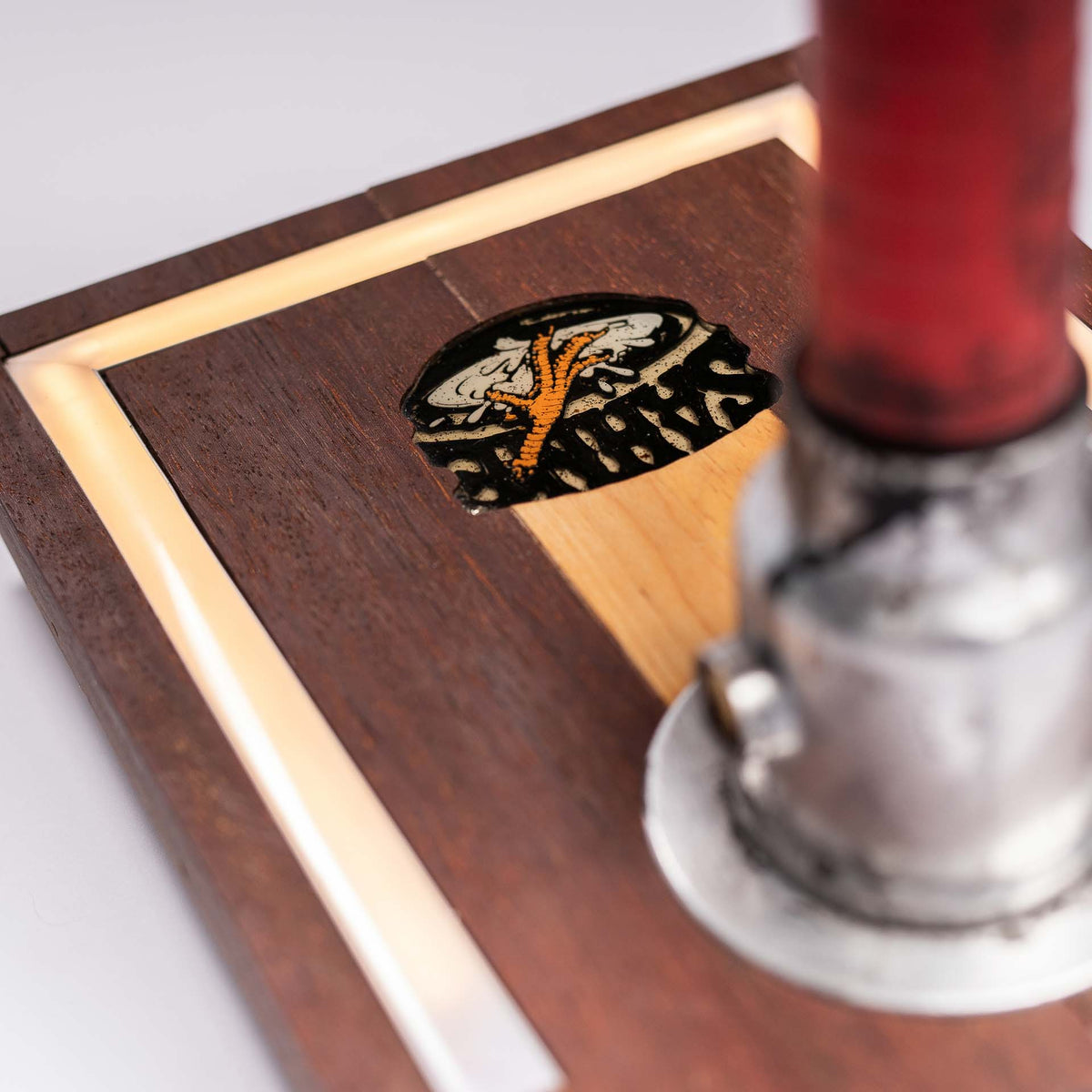 Detail of the wooden base with integrated LED lighting and the sahne.studio emblem